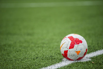 Close-up of soccer ball on field