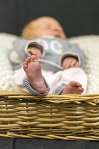 Newborn baby resting in wicker basket