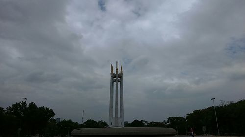 Low angle view of building against cloudy sky