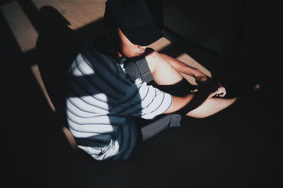 High angle view of man sitting on floor