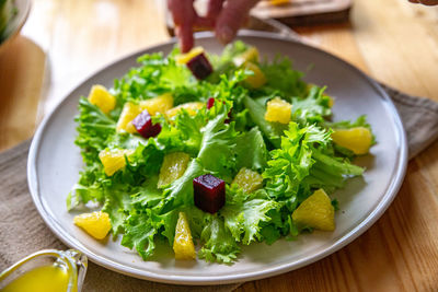 Caesar salad with copyspace on a wooden table on kitchen