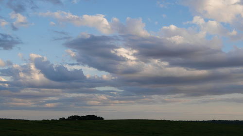 Scenic view of field against sky during sunset