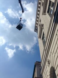 Low angle view of building against cloudy sky