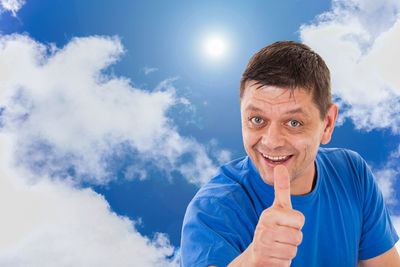 Portrait of smiling man against blue sky