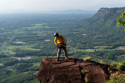 Man looking at mountain range against sky