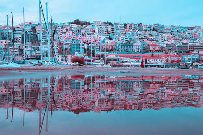 Reflection of building in lake against sky