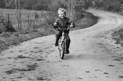 Full length of boy riding bicycle