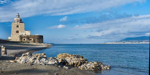 Historic building by sea against sky