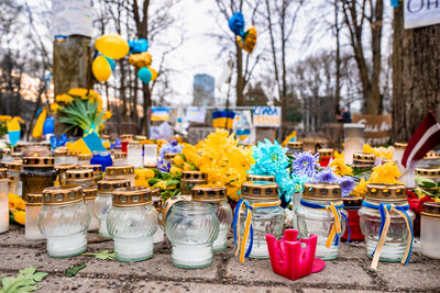 Thousands candles and flowers standing on the street during the war in ukraine