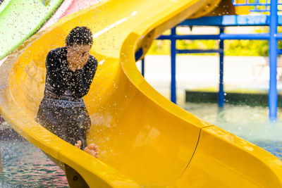 Close-up of yellow slide in playground