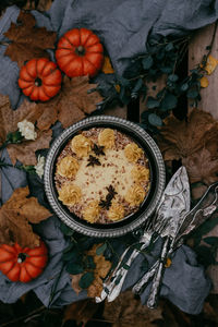 High angle view of pumpkins and leaves on table