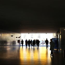 Group of people walking in corridor