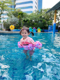 Portrait of boy playing in swimming pool