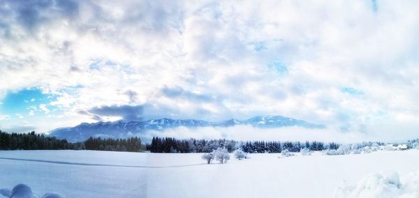 Scenic view of snowcapped landscape against sky