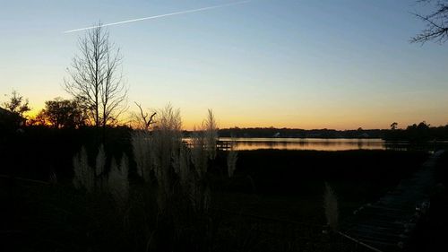 Scenic view of silhouette trees against sky at sunset