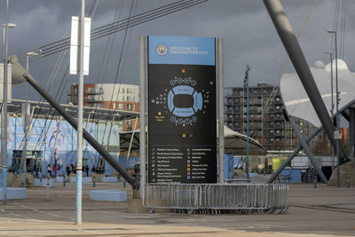 Information sign on bridge over street in city