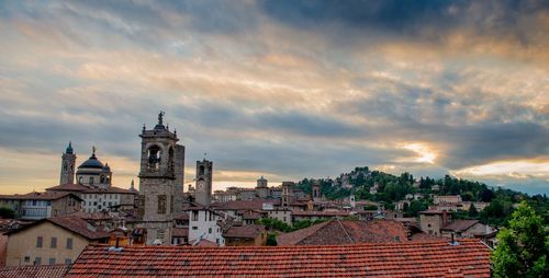 Bergamo at sunset in the old city with towers and bell tower