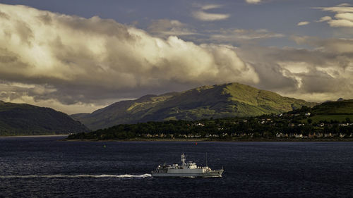 Naval vessel sails up river clyde, scotland.