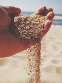 Close-up of hand holding sand