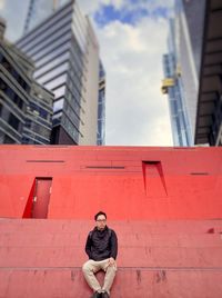 Low angle view of woman standing against building