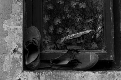 Abandoned shoes by window
