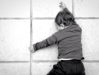 Directly above view of boy lying on floor