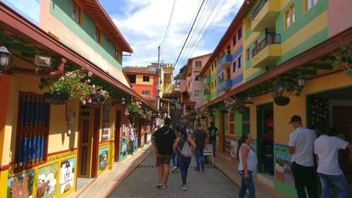 People walking on street amidst buildings in city