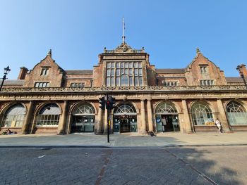 Facade of historic building against clear blue sky