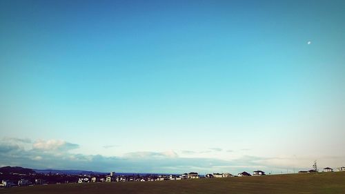 Scenic view of landscape against blue sky