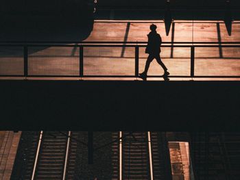 Low angle view of silhouette people walking in city