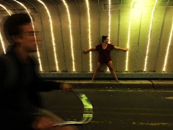 Full length of woman standing in illuminated building