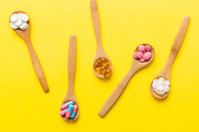 High angle view of heart shapes on yellow background