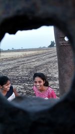 Portrait of smiling woman lying on land