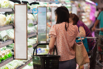 Woman buying at supermarket