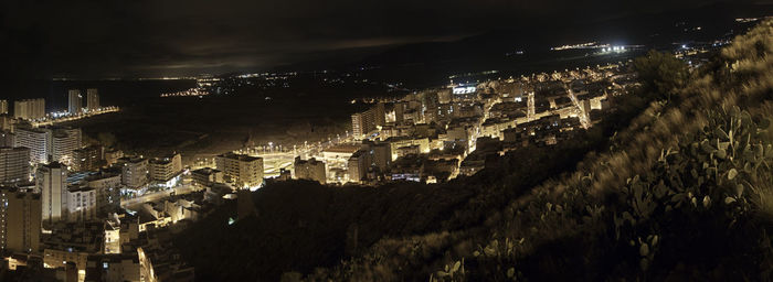 High angle view of illuminated buildings in city at night