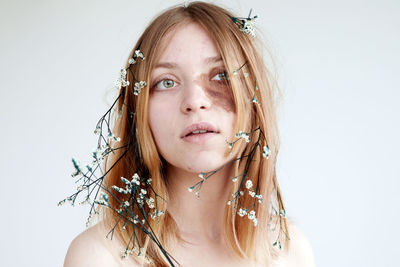 Close-up portrait of a beautiful young woman over white background