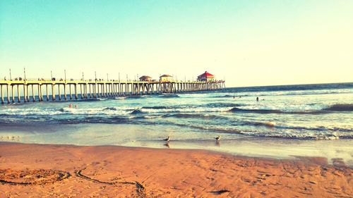 Huntington beach pier in sea against clear sky