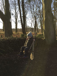 Boy working on tree in field