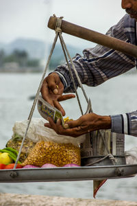 Man holding ice cream in basket