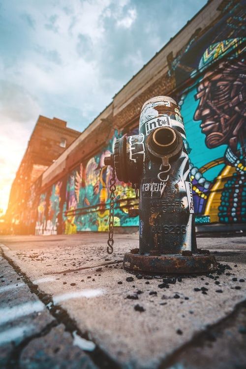 creativity, sky, architecture, art and craft, cloud - sky, text, day, nature, communication, building exterior, no people, western script, built structure, road, graffiti, human representation, outdoors, transportation, city, representation, mural