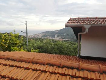 Houses against cloudy sky