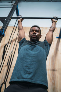 Low angle view of man exercising in gym