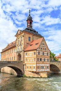 Arch bridge over river against buildings