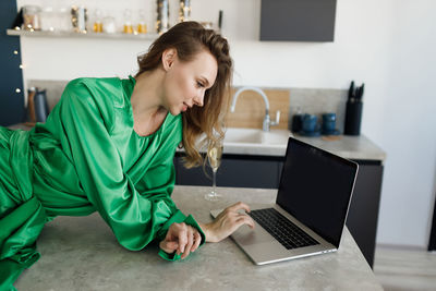 Young woman using laptop at home