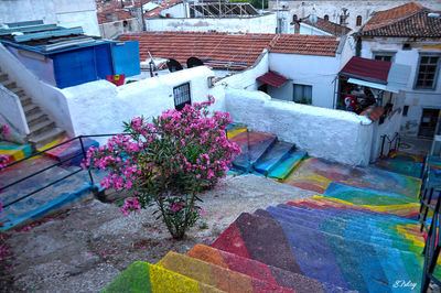 High angle view of multi colored houses on street amidst buildings