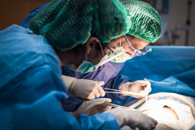 Surgeons performing surgery in operating room