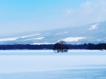 Scenic view of snow covered landscape against sky