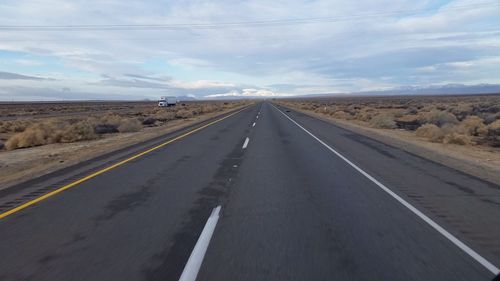 Road by landscape against sky