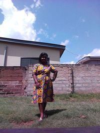 Rear view of woman standing against building