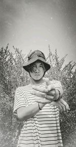 Full length of boy standing by tree